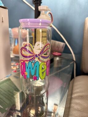 Clear Tumbler with Purple Lid and Colorful Bow Design. 20 ounce